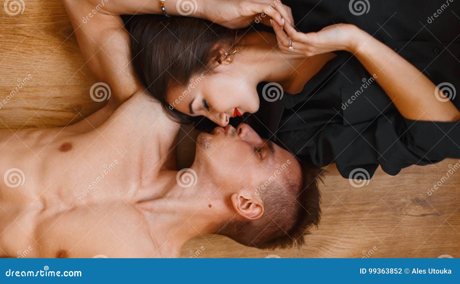 stock photo young couple lying wooden